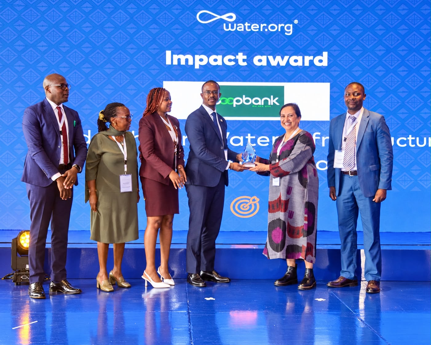 Ms Vedika Bhandarkar, President and Chief Operating Officer, Water.org (second right) presents the Leadership in Water Infrastructure and Finance Award to Ben Muriuki, Head of Investor Relations & Strategy at Co-op Bank.